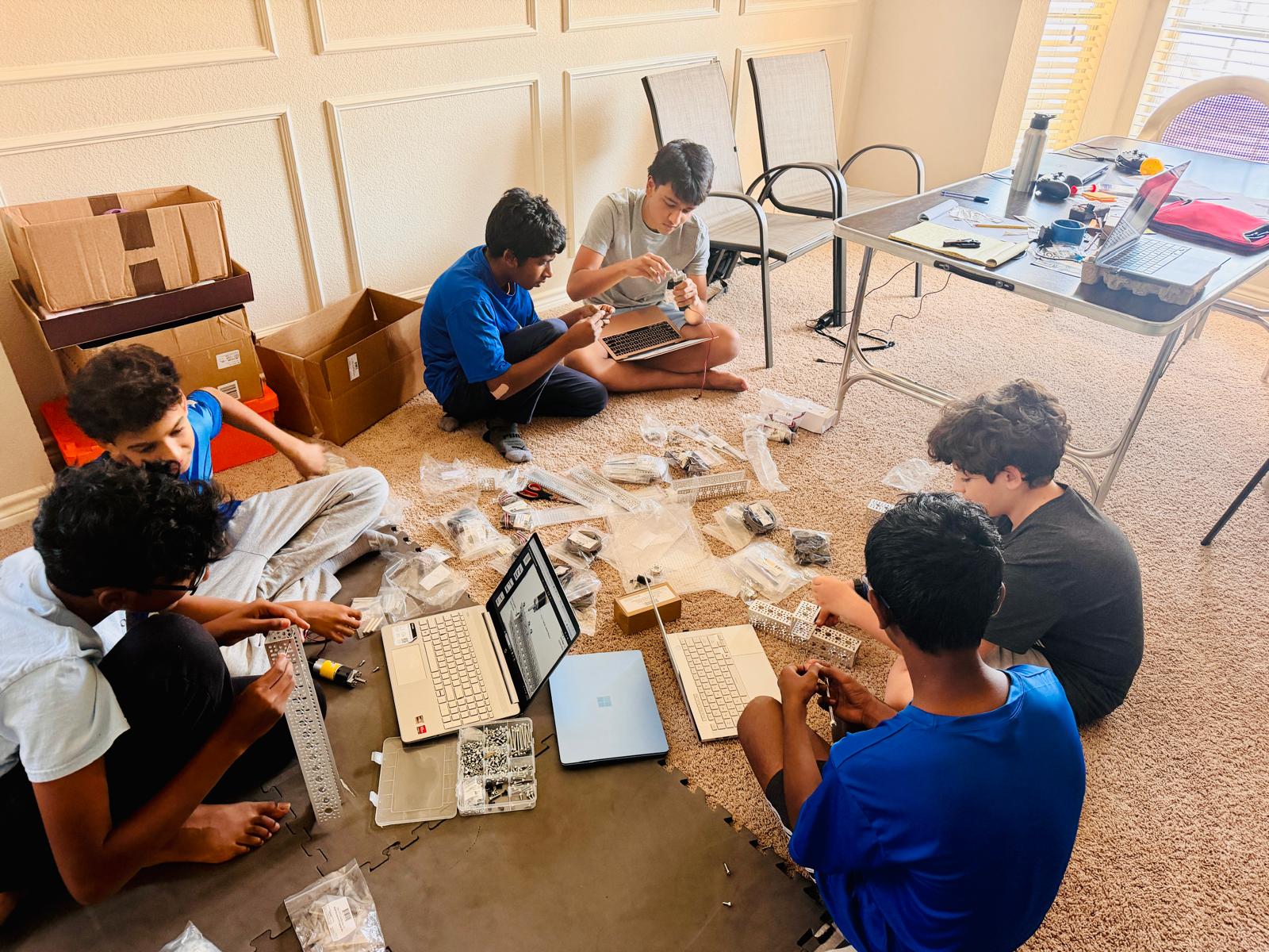 Techs Mechs students building the BioBuzz robot during build session 2